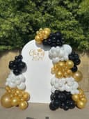 Black, white and gold garland around a Class of 2024 arch