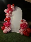 Red and pink garland with heart foils, set up at night